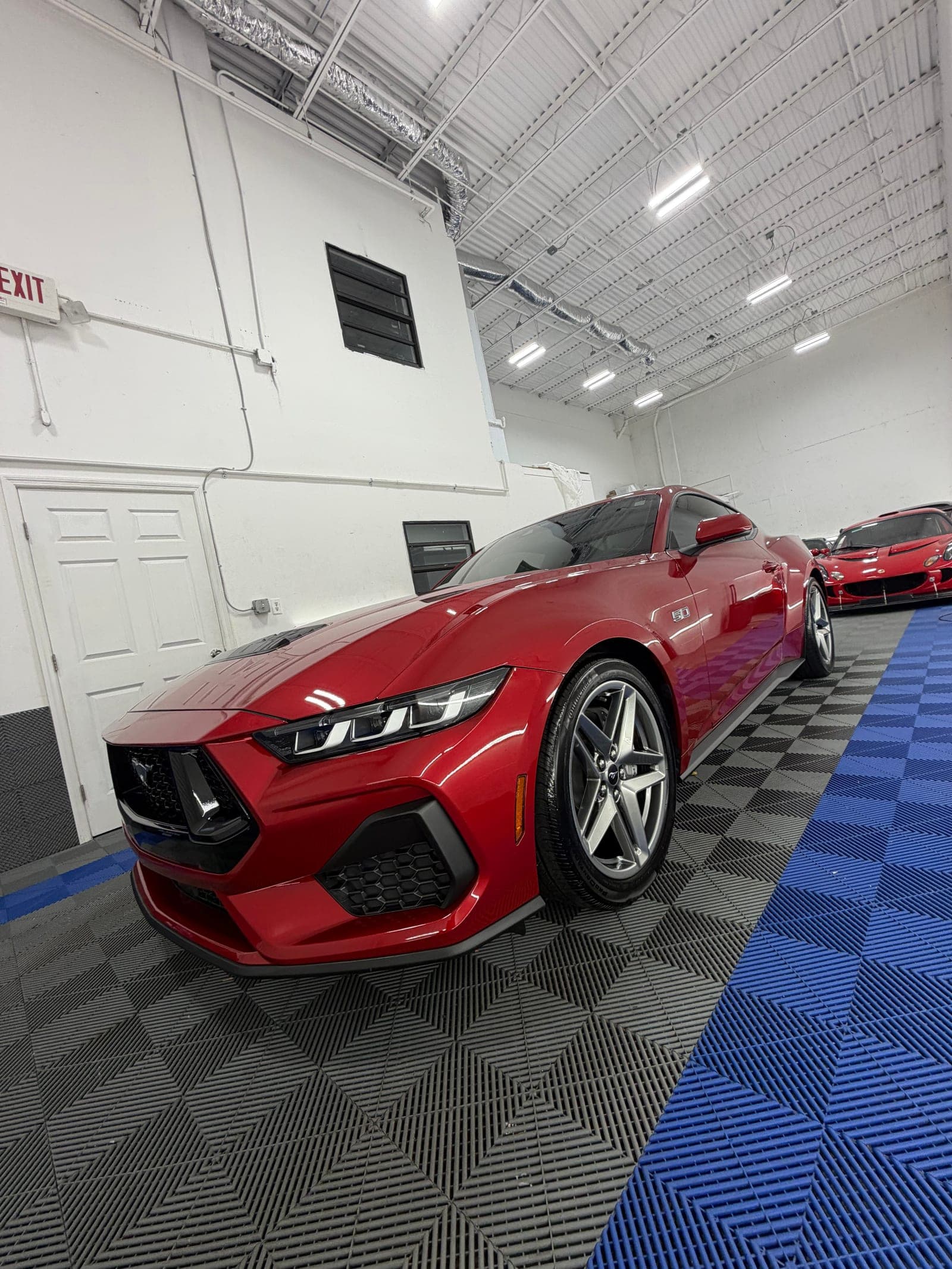 Overhead shot of a red Corvette after a full detail inside the Oakland Park shop