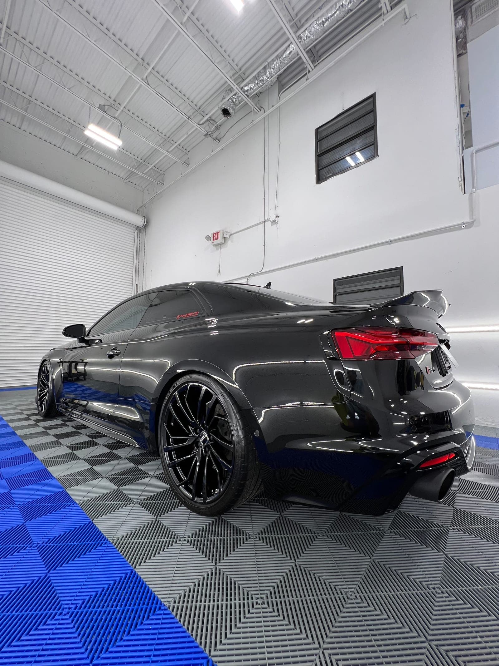 Slate-gray McLaren rear after paint correction — no swirls, deep gloss