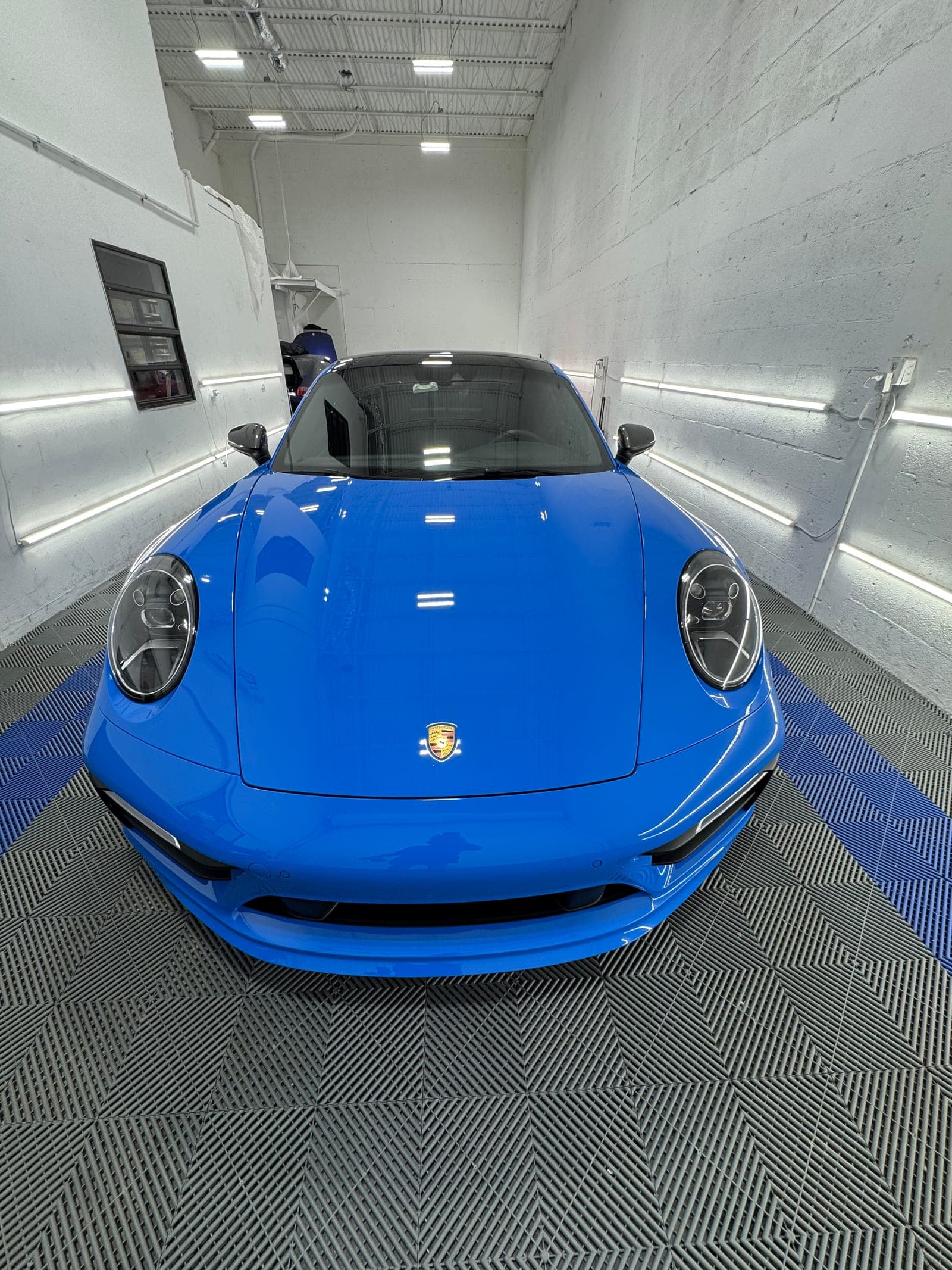 Shark-blue Porsche 911 fresh from a full paint correction and ceramic coat