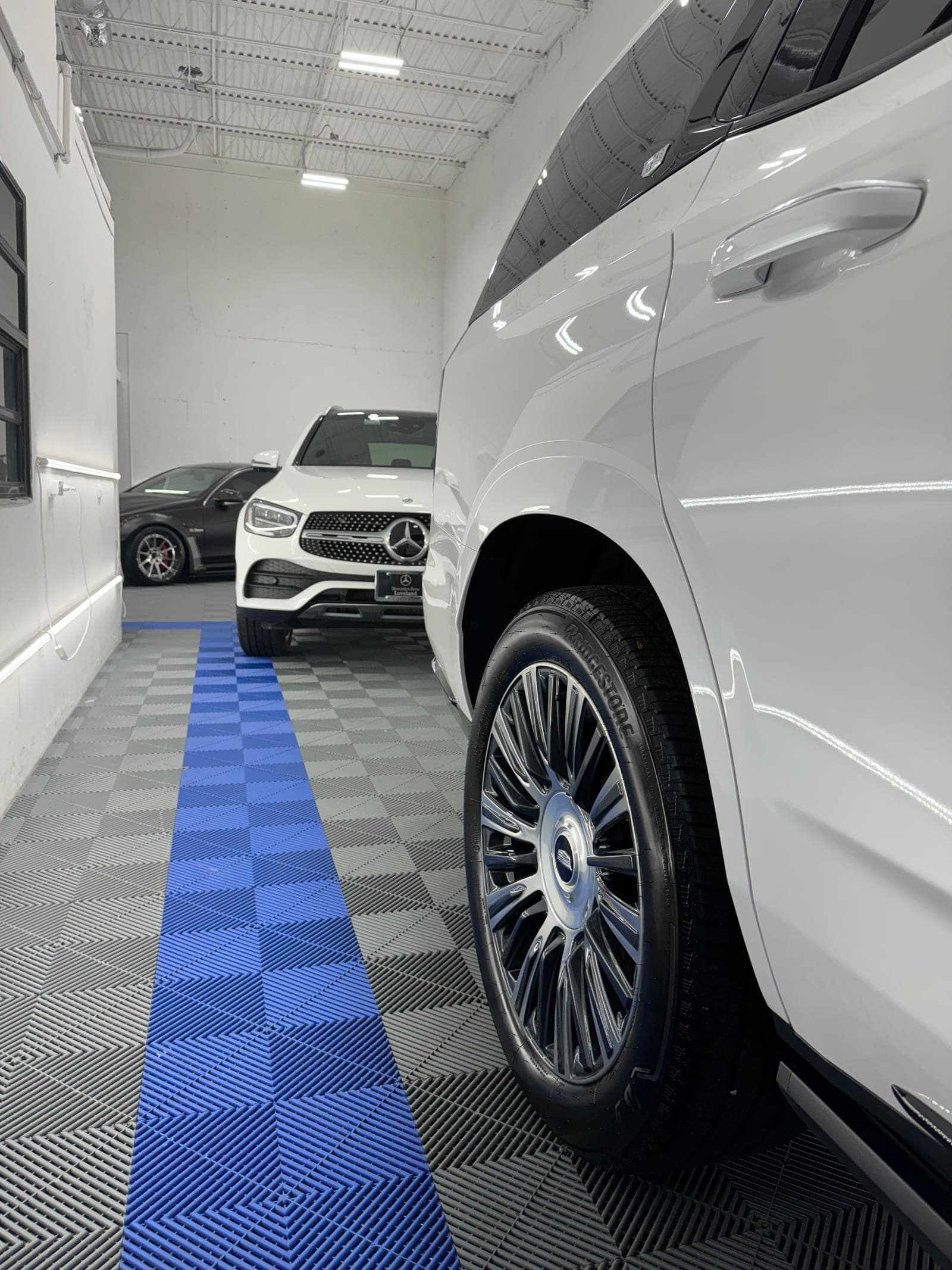 White Rolls-Royce wheel and lower paint after a full exterior detail