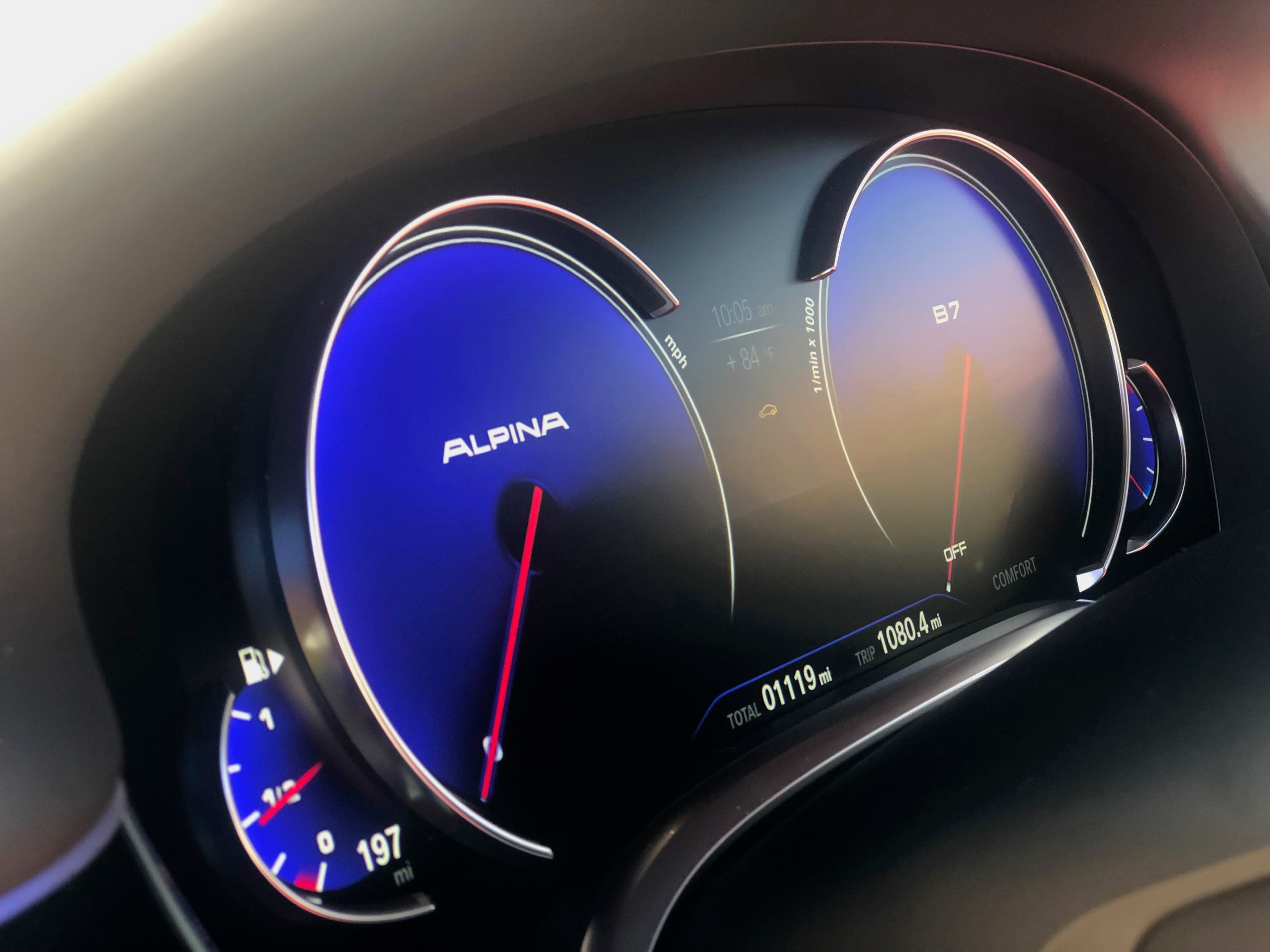 BMW Alpina B7 gauge cluster — backlit blue dials and ambient interior detail