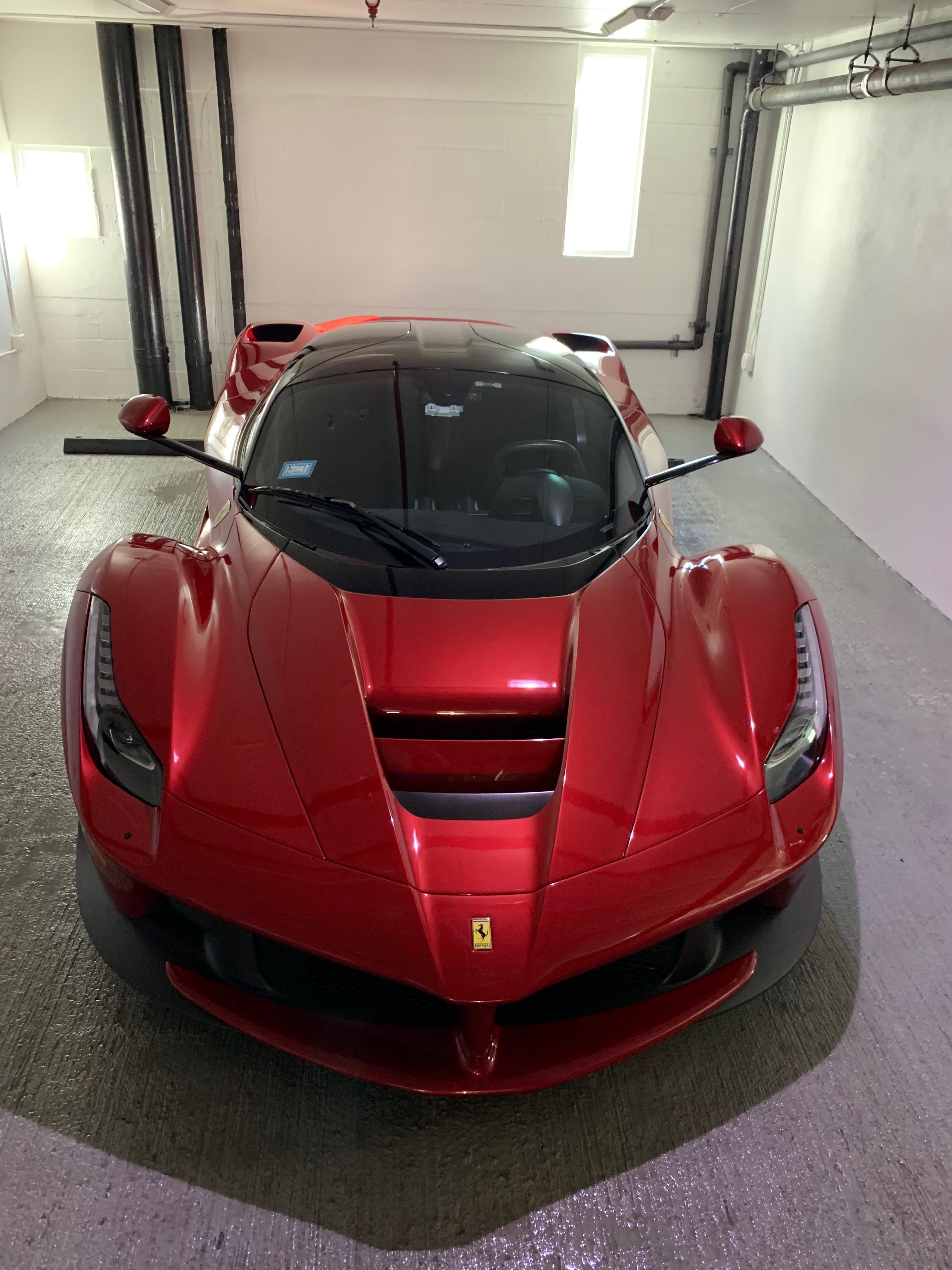 Red Ferrari LaFerrari in the Sunflo detail bay after a full exterior detail and paint inspection