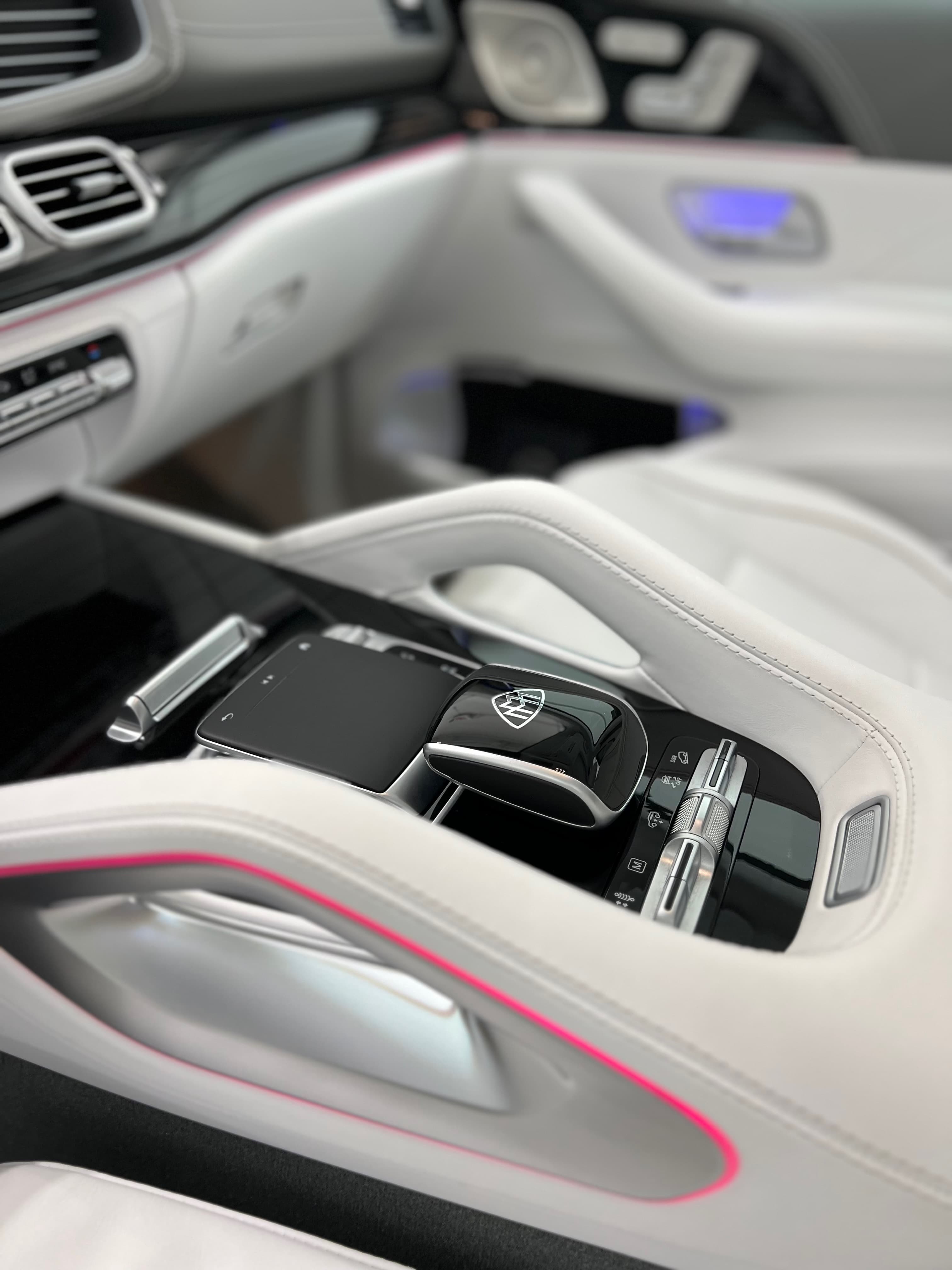 Mercedes-Maybach center console and white nappa leather seats with pink piping after a full interior detail