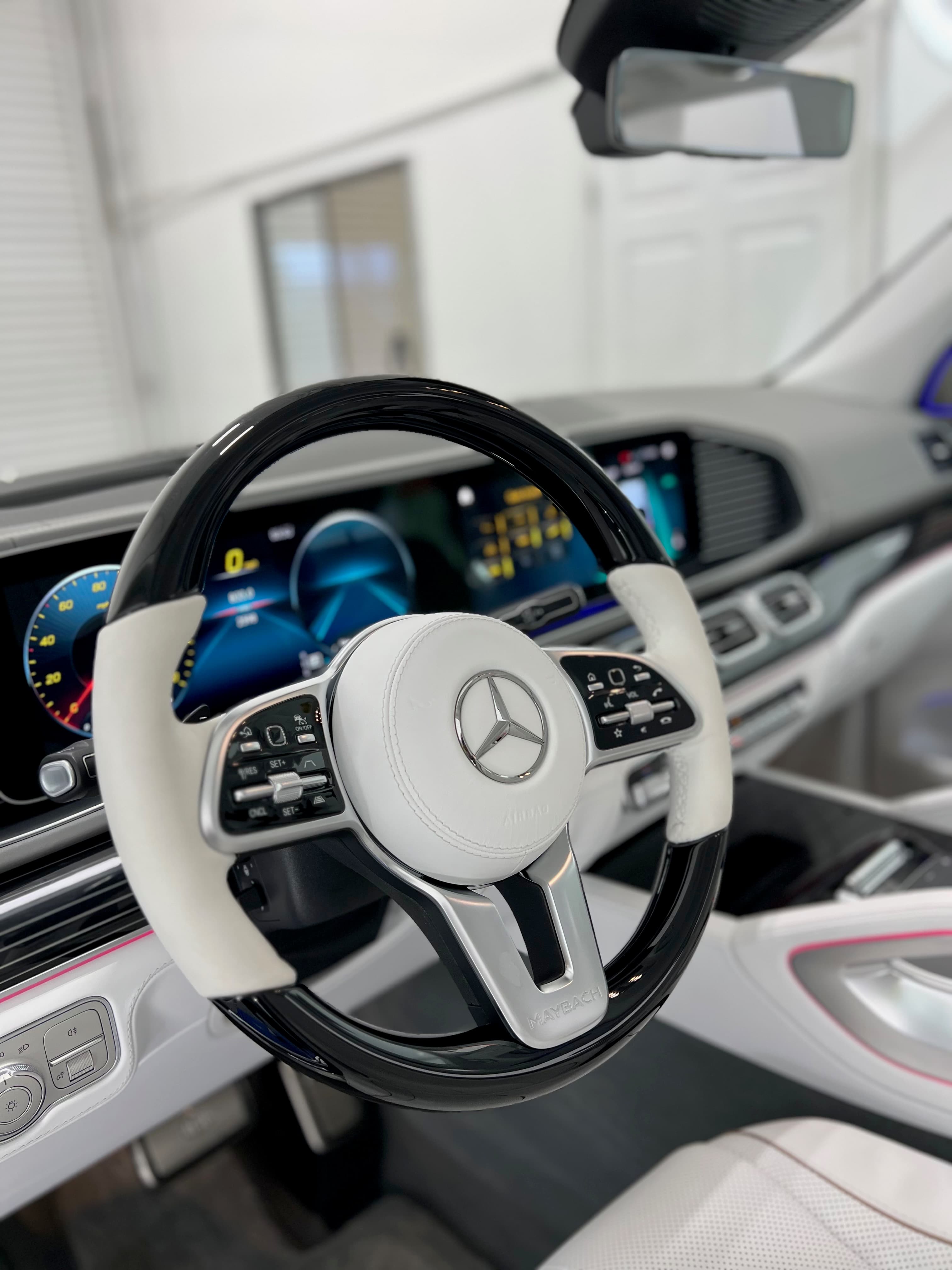 Mercedes-Maybach two-tone steering wheel — black piano lacquer with white nappa leather, after a full interior detail