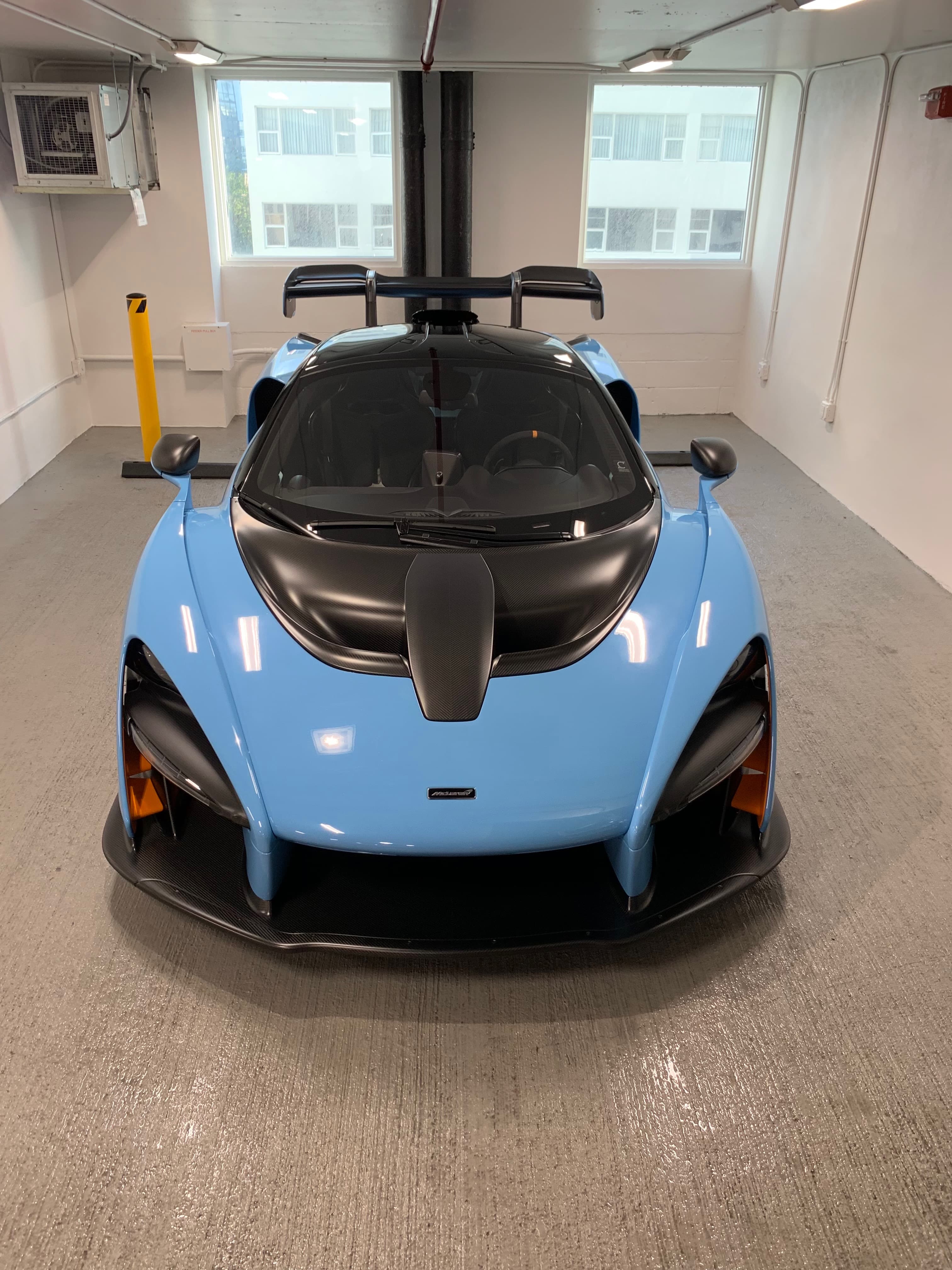 Baby blue McLaren Senna front-on with carbon fiber bonnet and active rear wing inside the Fort Lauderdale studio