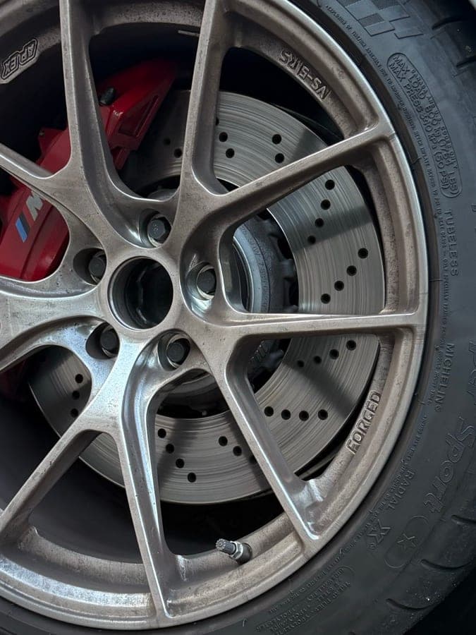 Before detailing — dirty brake-dust covered wheel
